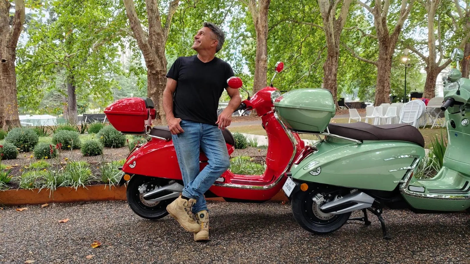 jamie durie at the Melbourne Flower international show standing next to 2 ROLL'N electric mopeds motorbikes
